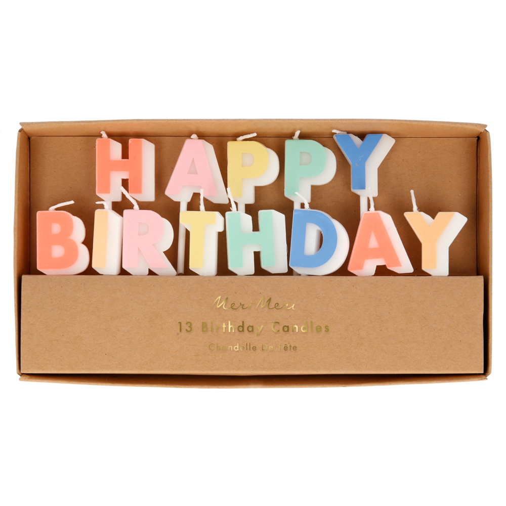 A set of 13 colorful letter candles spelling 'HAPPY BIRTHDAY' displayed inside a brown cardboard gift box. The letters are in pastel shades of pink, orange, yellow, green, blue, and purple, with white wicks.