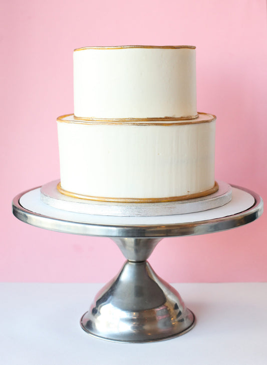 Two-tier cake finished with a gold rim accent
