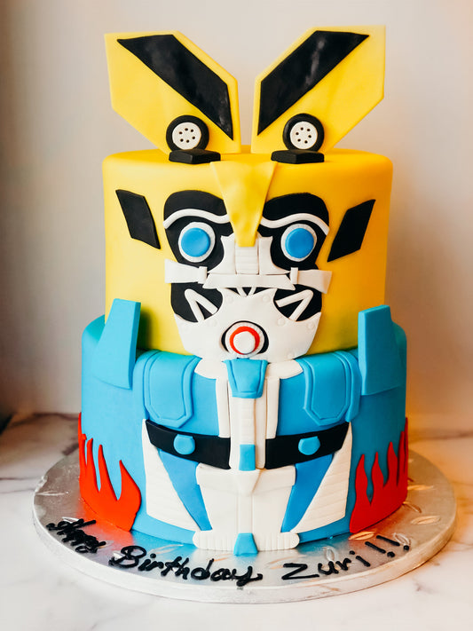 Two-tier cake decorated with a Transformers theme