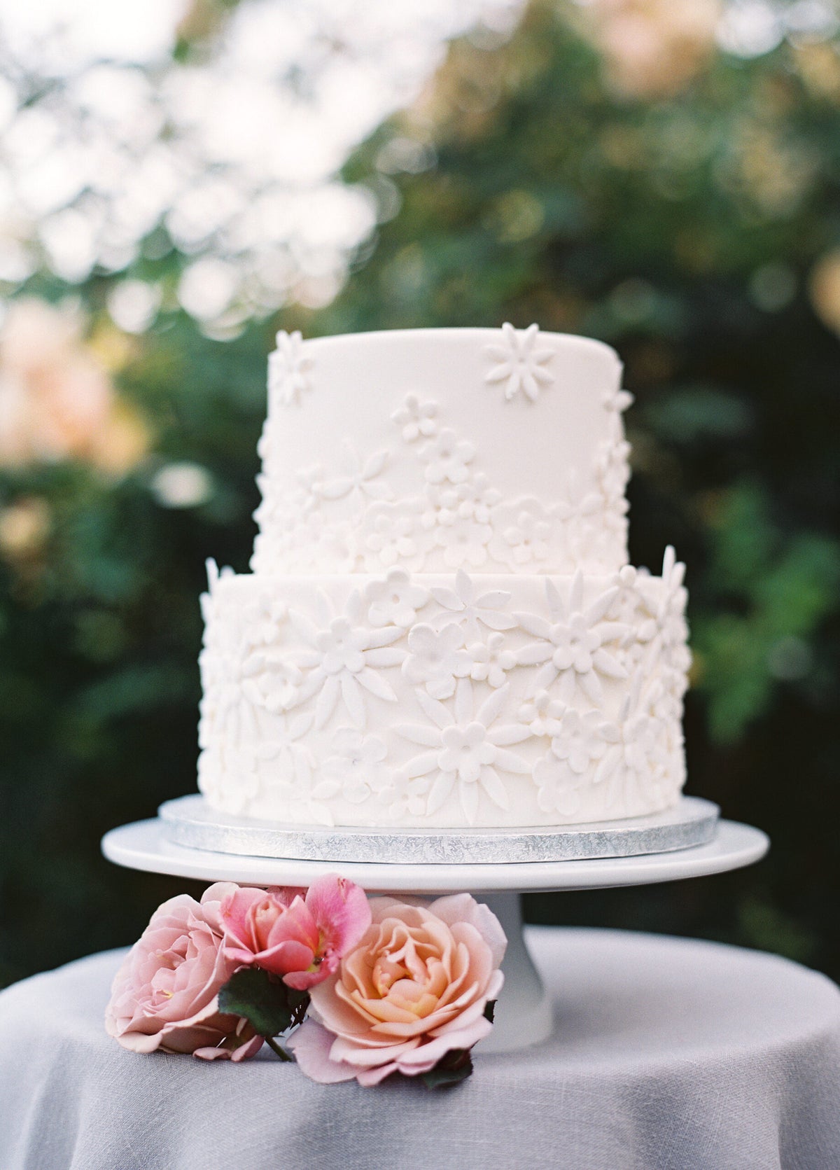 Two-tier cake decorated with handmade fondant flowers