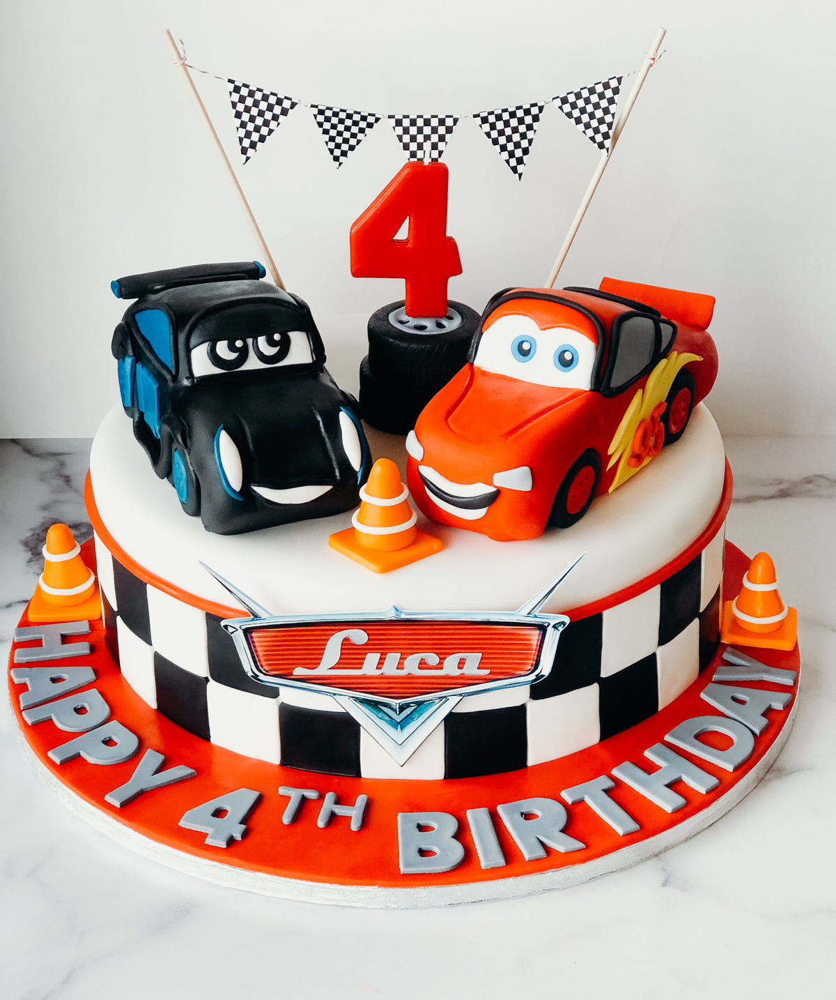 3D sculpted birthday cake shaped like a race car