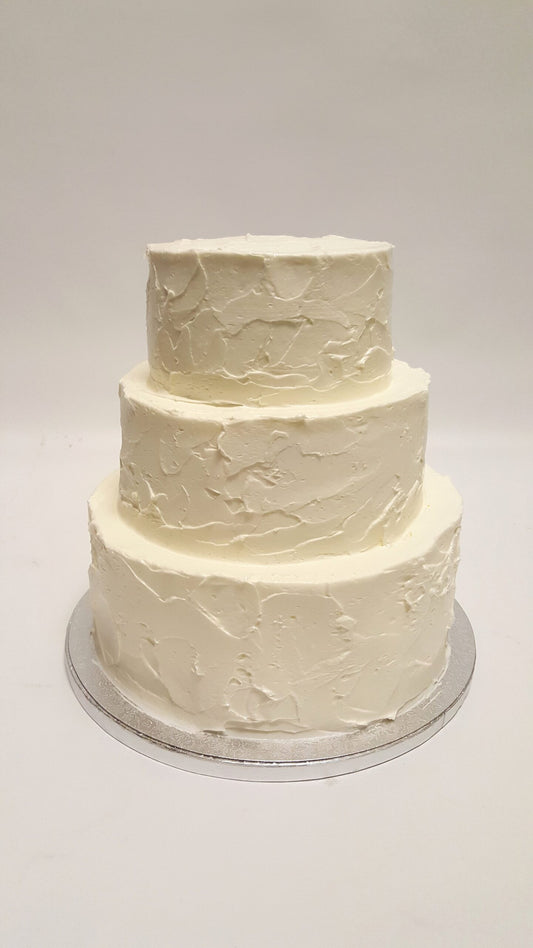 Three-tier wedding cake with hand-piped textured buttercream finish