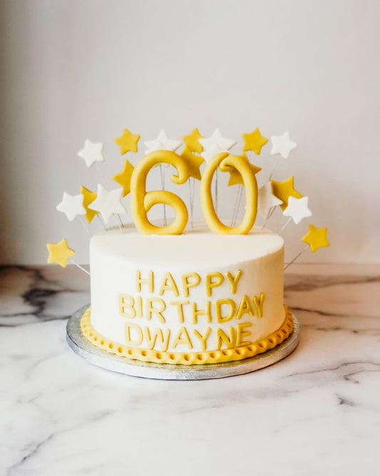 Birthday cake decorated with fondant stars and a custom age number topper