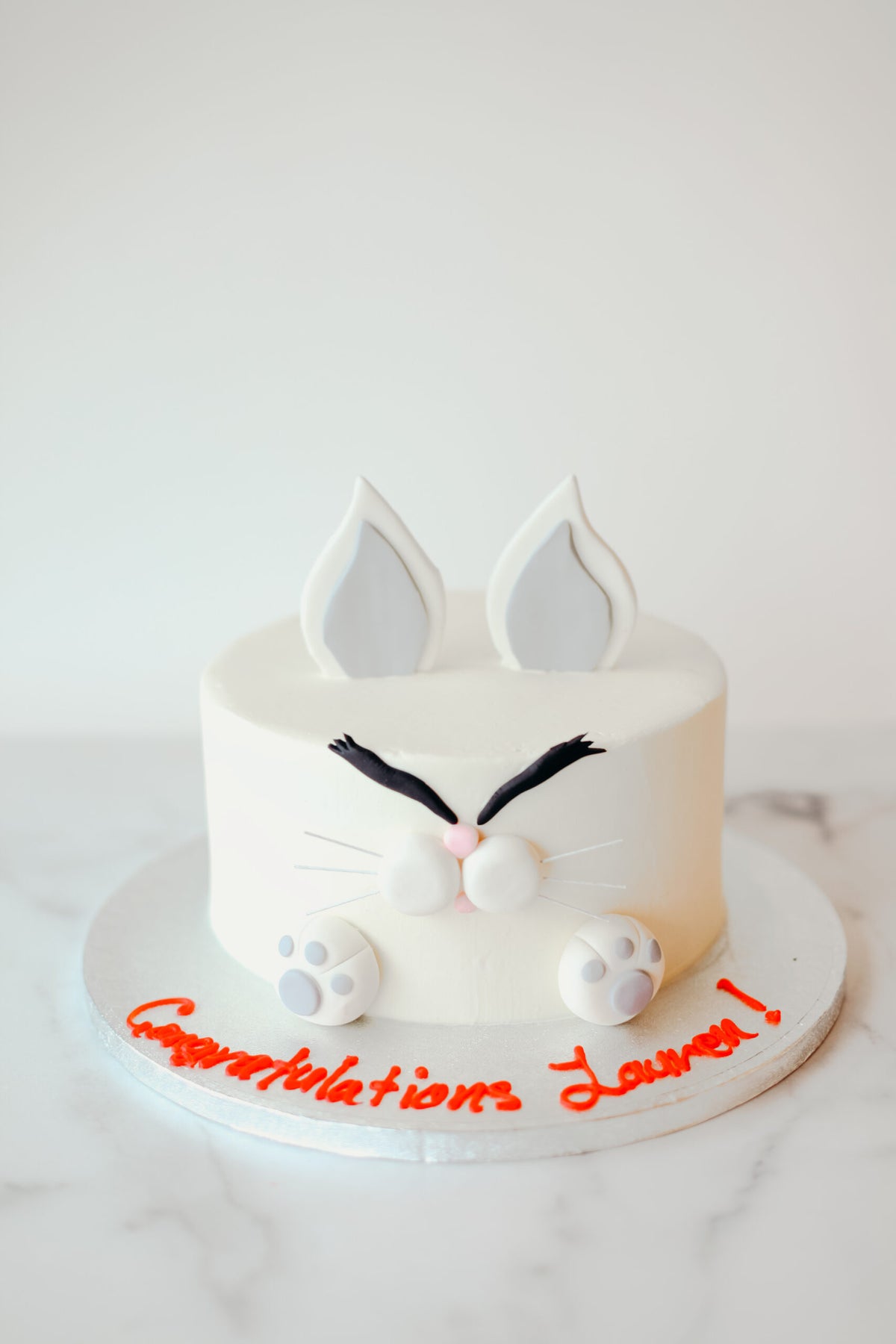 Custom cake decorated with a cartoon angry bunny character