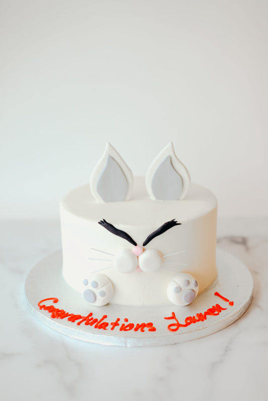 Custom cake decorated with a cartoon angry bunny character