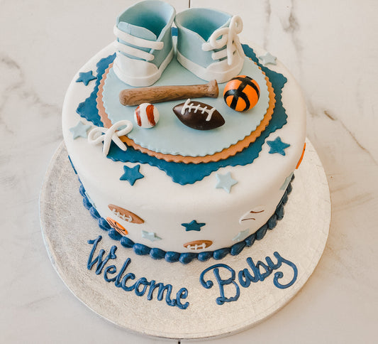 Baby shower cake decorated with a sports theme