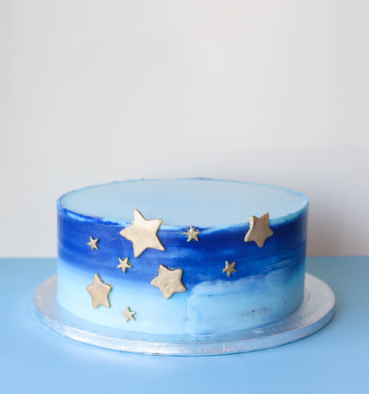 Cake decorated with blue and gold star accents