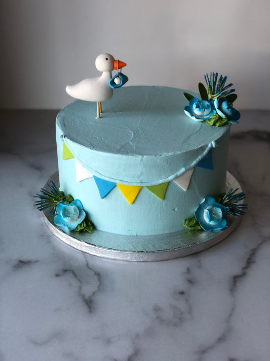 Baby shower cake decorated with a blue fondant stork