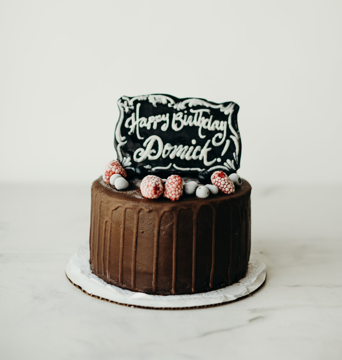 Chocolate cake with a personalized name plate topper