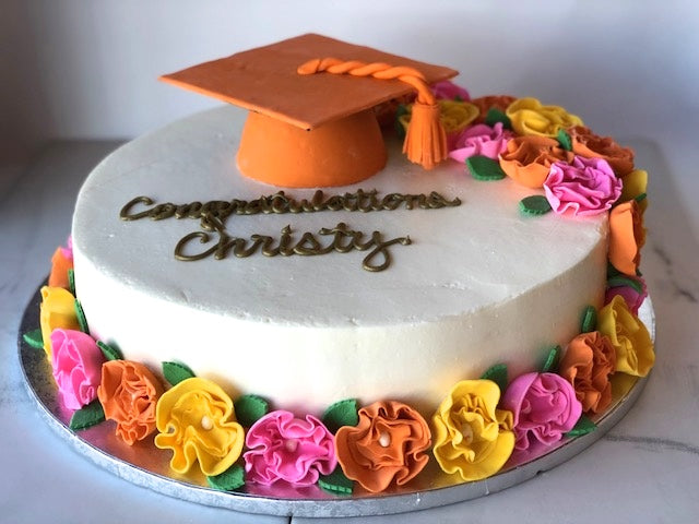 Graduation cake decorated with colorful floral piping