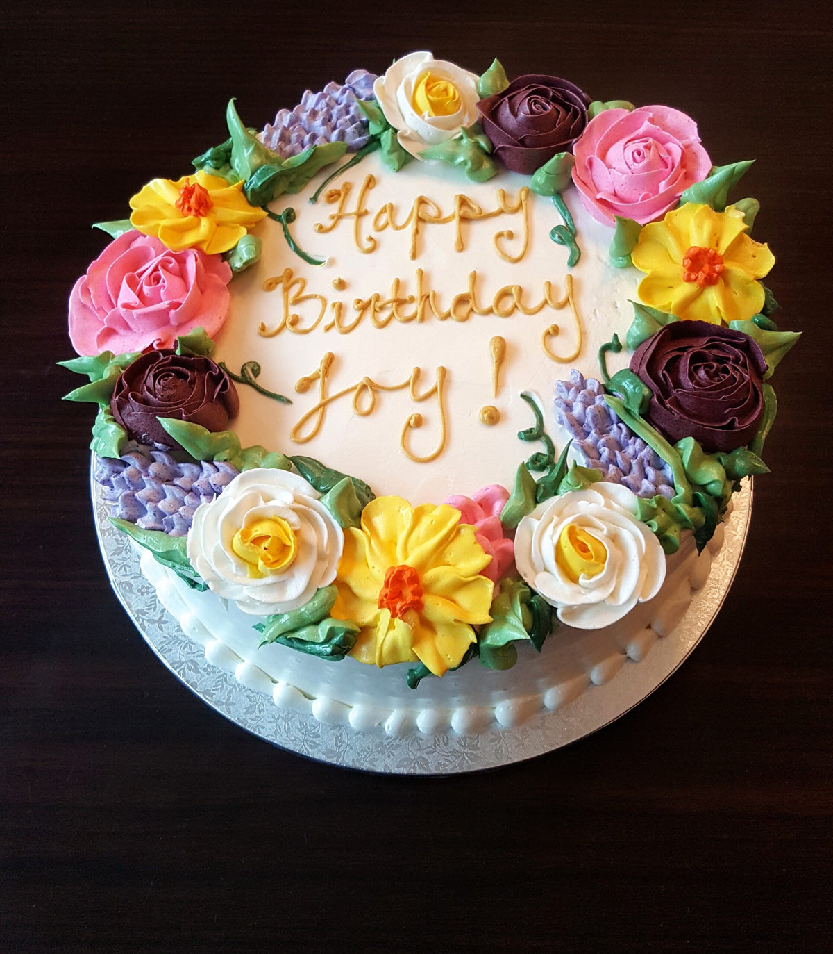 Cake decorated with colorful floral piping