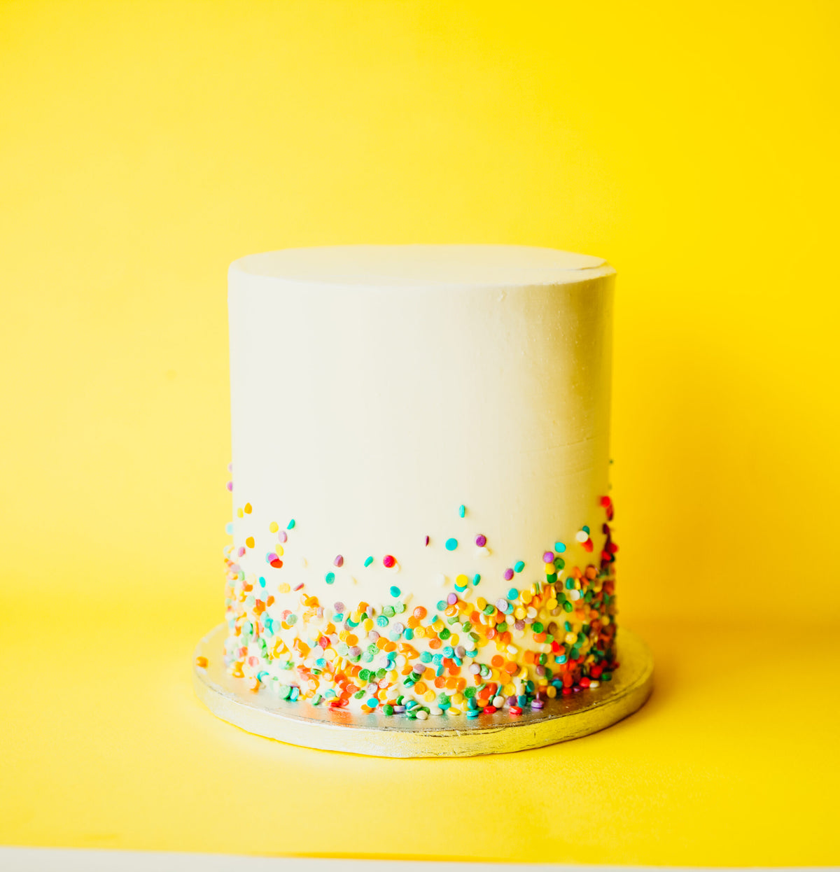 Cake covered in a double layer of rainbow sprinkles