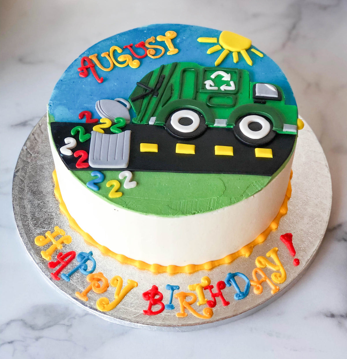 Birthday cake sculpted and decorated like a recycling truck
