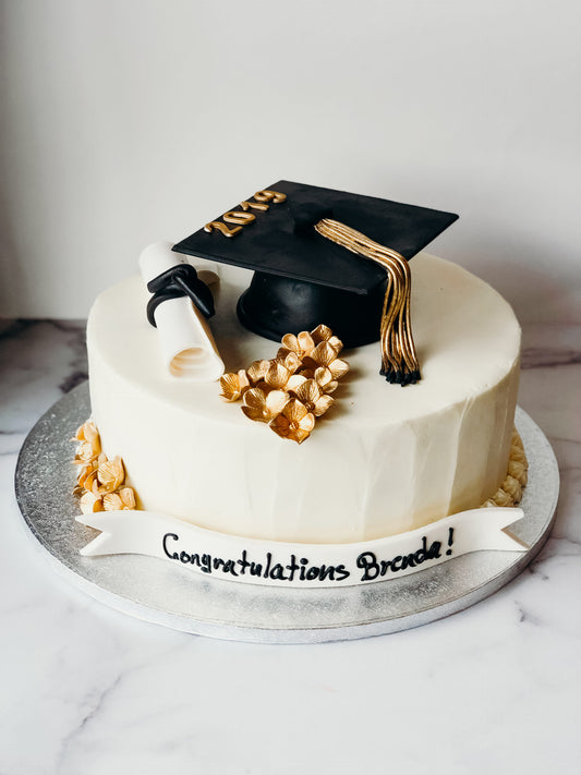 Graduation cake decorated with gold floral accents