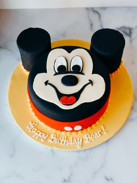 Birthday cake with a Mickey Mouse silhouette cutout design