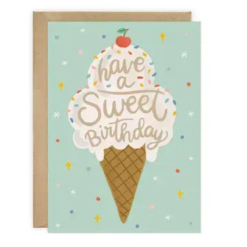 A square birthday card with a kraft envelope behind it, featuring an illustrated ice cream cone on a pale mint background with the words 'have a Sweet Birthday' and small confetti and star accents.