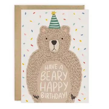 A birthday card featuring a hand-drawn bear wearing a green party hat, with the text 'HAVE A BEARY HAPPY BIRTHDAY!' on a white card, shown with a kraft envelope behind it.