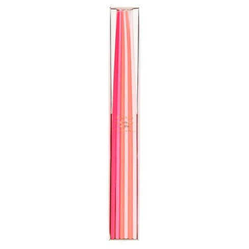 A set of six pastel-colored candles in a slim clear plastic tube packaging, featuring shades of pink, coral, and peach on a solid white background.