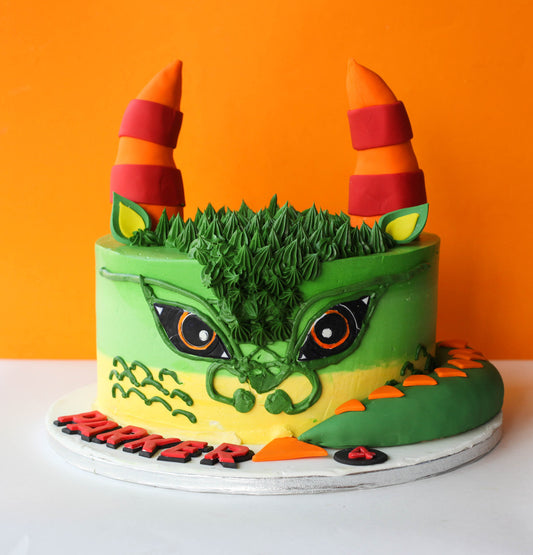Custom birthday cake decorated with a sculpted fondant dragon