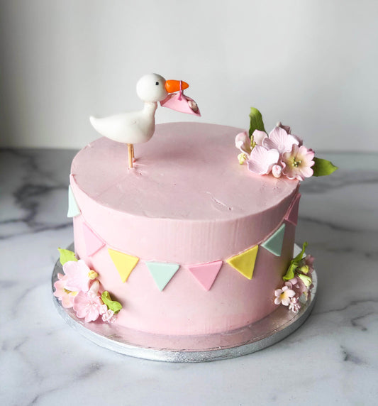 Baby shower cake decorated with a pink fondant stork
