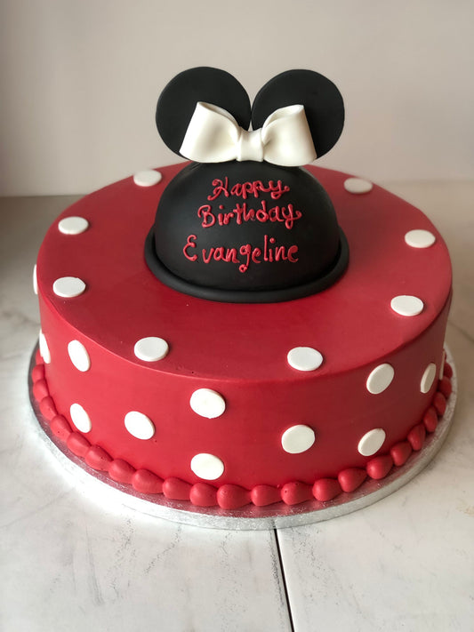 Two-tier cake decorated with a Minnie Mouse theme