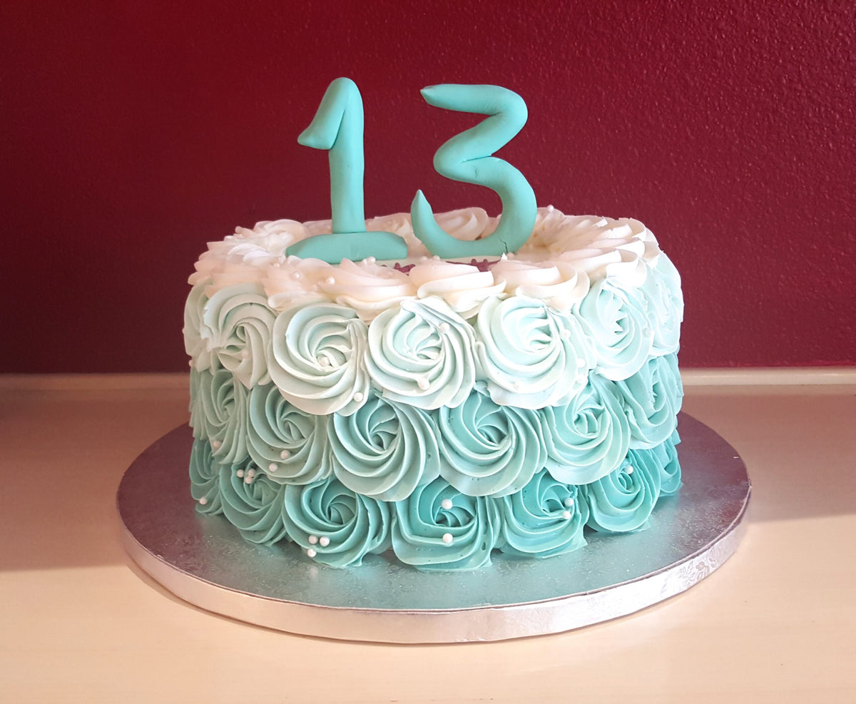 Rosette-piped cake topped with a number decoration