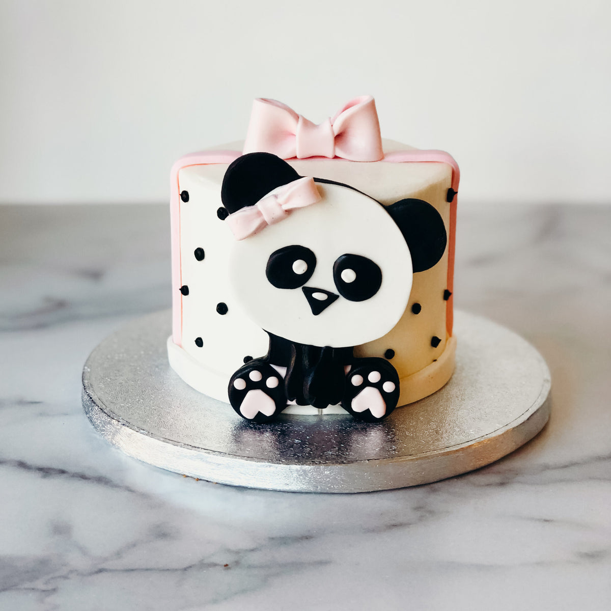 Custom cake decorated with a pink panda design