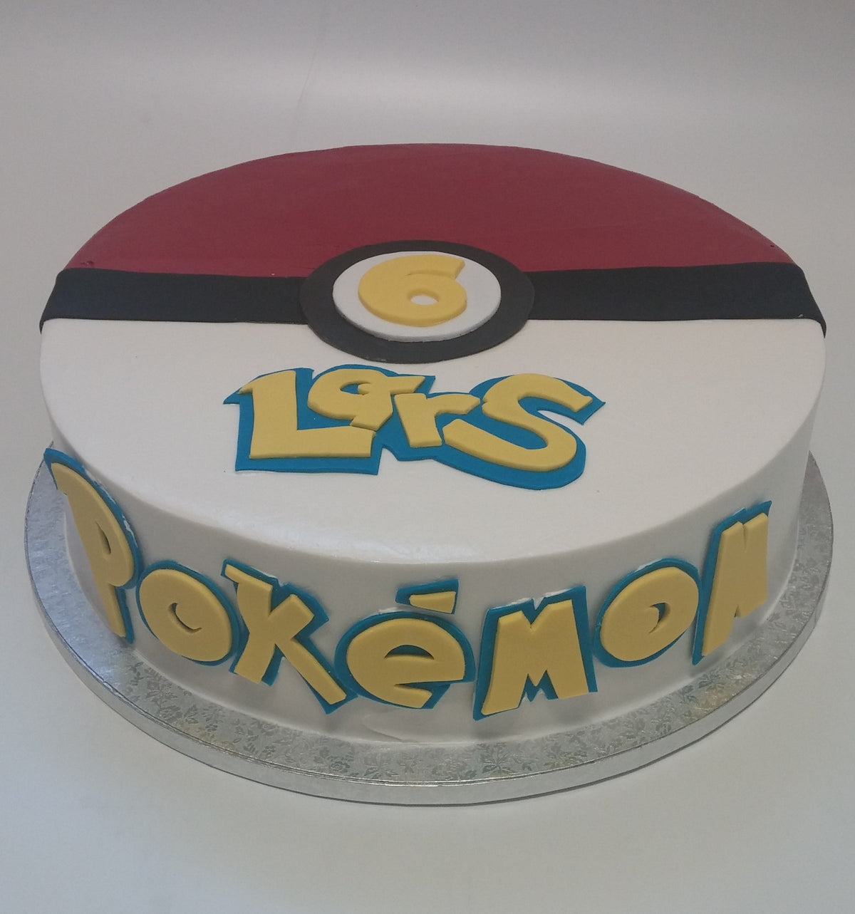 Pokemon-themed birthday cake with sculpted character fondant details