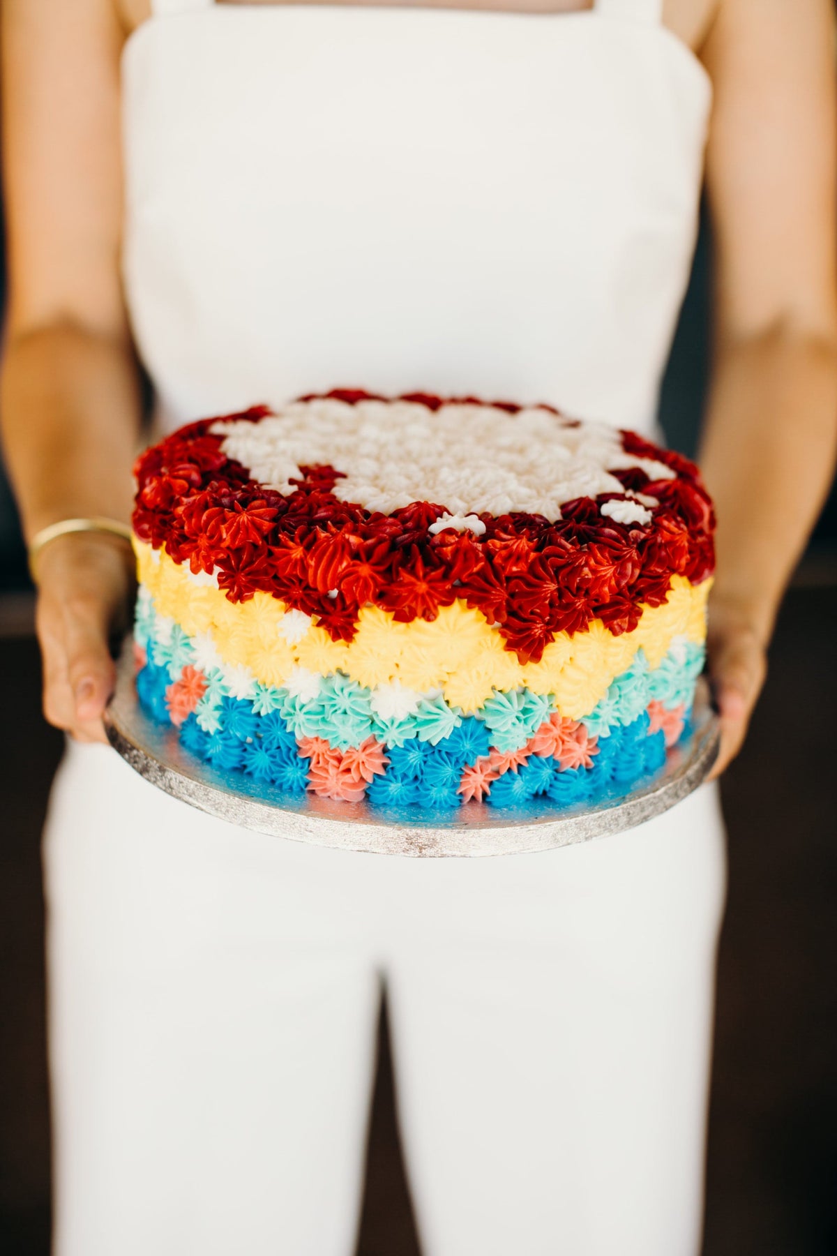 Cake decorated with rainbow-colored piping