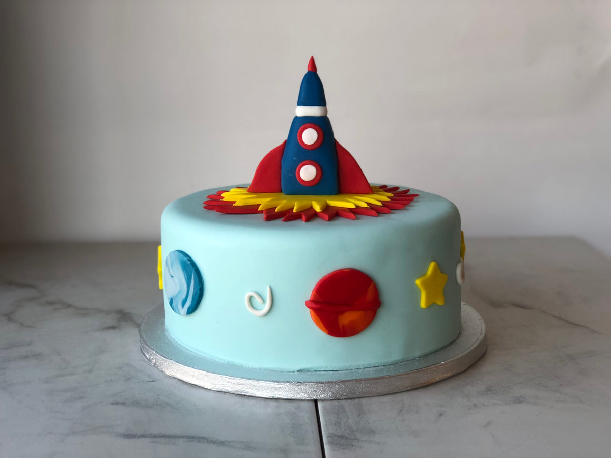 Cake sculpted and decorated as a rocket ship