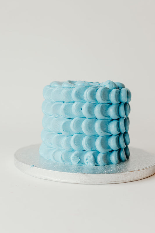 Blue textured buttercream cake with a simple, classic finish