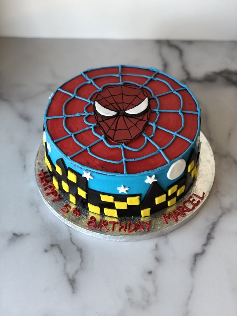 Spider-Man birthday cake in a bold red and blue web design