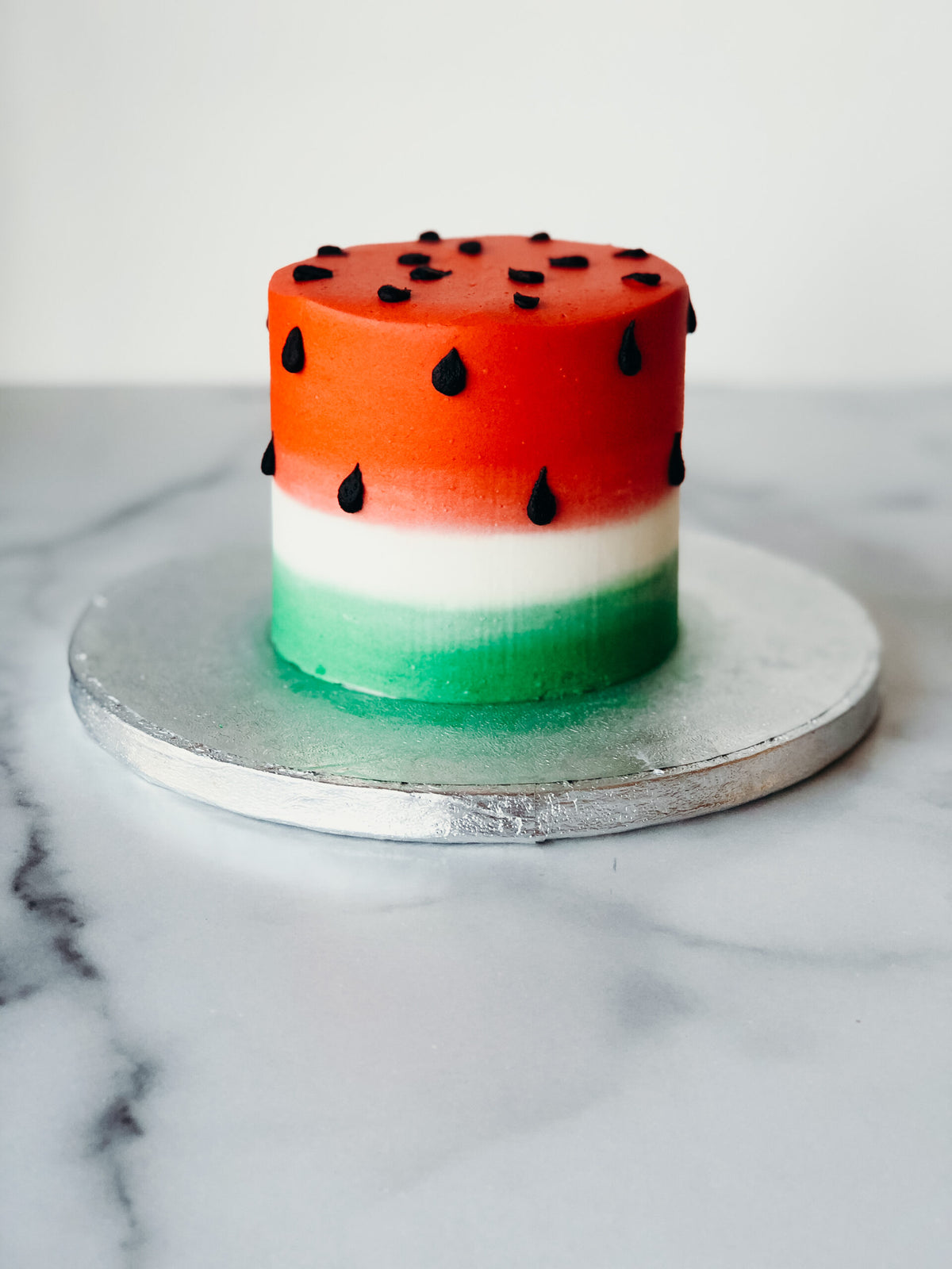 Watermelon-themed birthday cake with a double-stacked fruit design