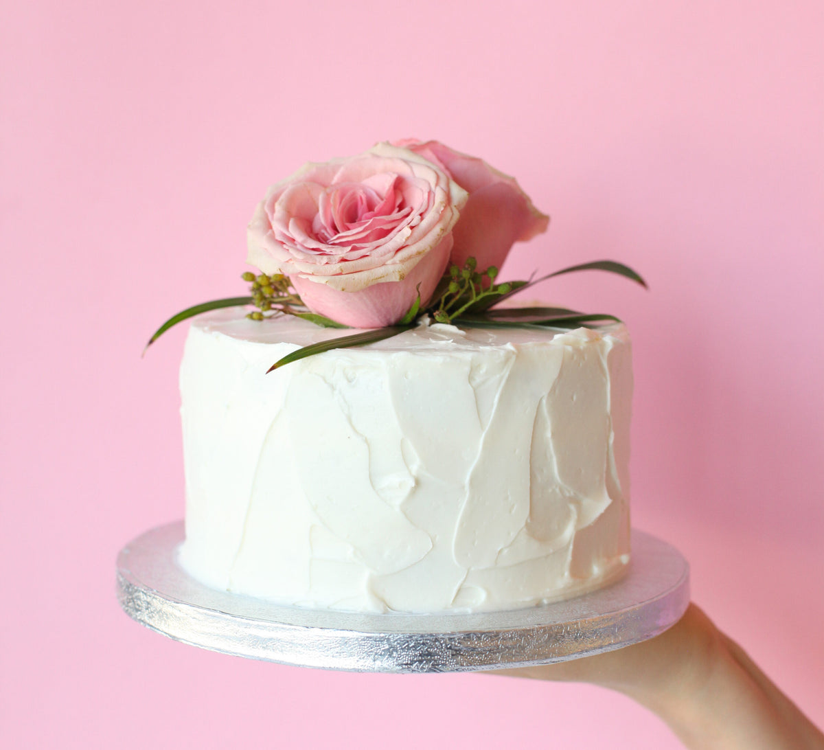 Elegant white textured wedding cake with a classic buttercream finish