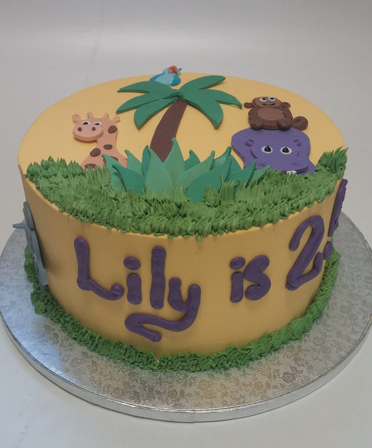 Cake decorated with a yellow safari animal theme