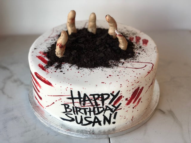 Halloween zombie-themed birthday cake with spooky fondant detailing