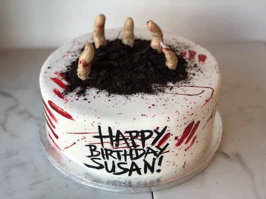 Halloween zombie-themed birthday cake with spooky fondant detailing