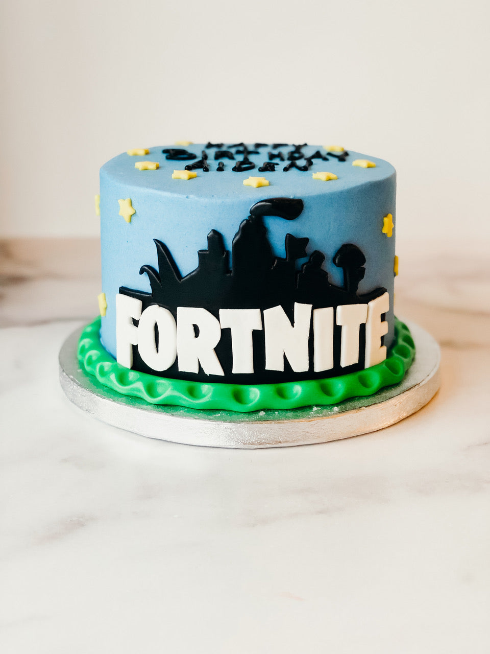 Fortnite-themed birthday cake with game-inspired fondant decorations