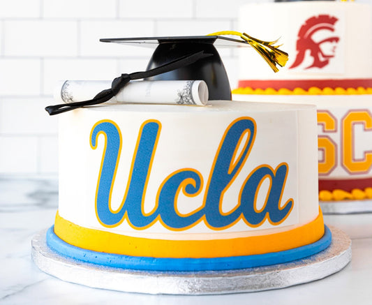 Two-tier graduation cake with cap and diploma decorations