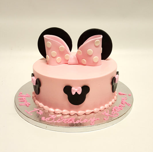 Minnie Mouse birthday cake in pink with a signature polka-dot bow